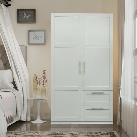 a bedroom with white furniture and decor in it