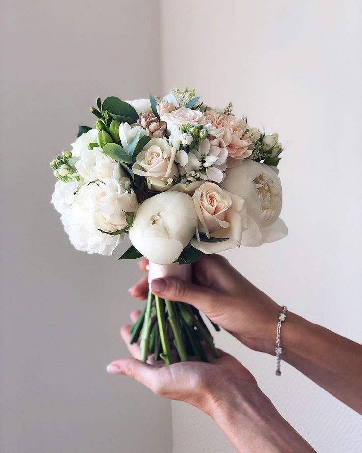 a person holding a bouquet of flowers in their hand