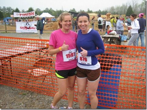 two women standing next to each other at a race