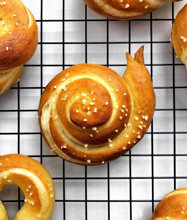 several buns with sesame seeds on a cooling rack