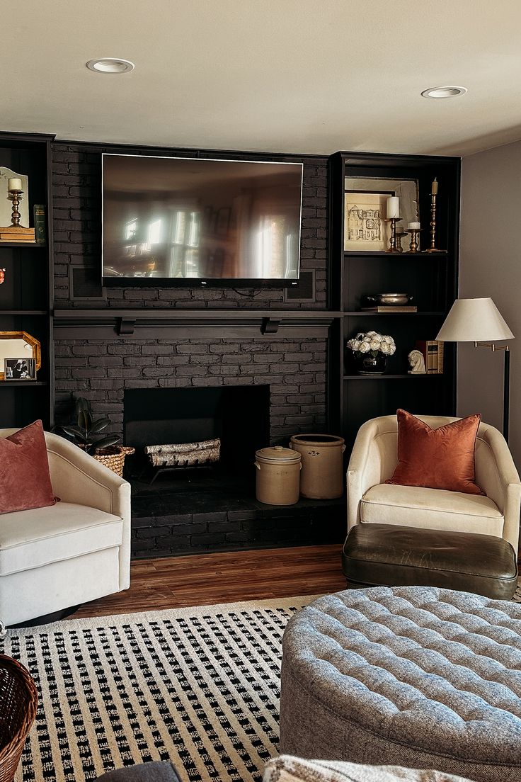 a living room with two couches and a television mounted on the wall above it