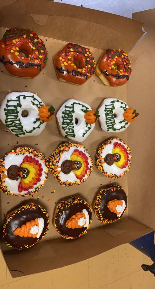 a box filled with lots of donuts covered in frosting