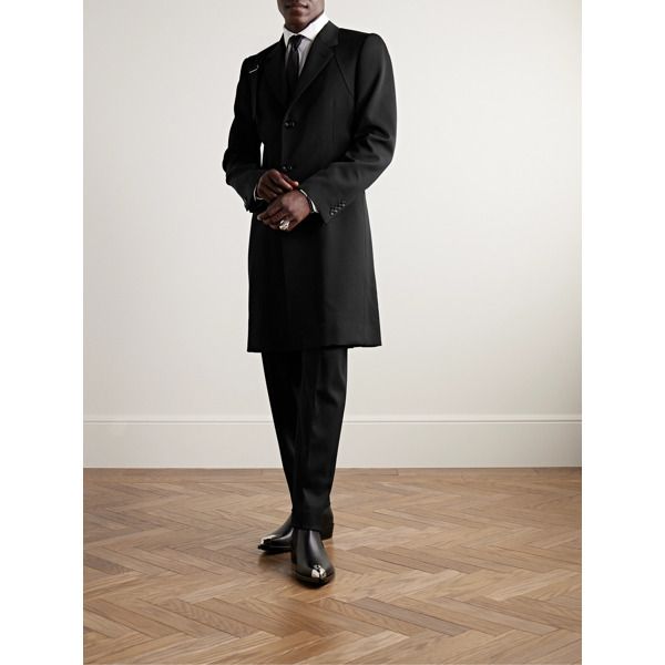 Alexander McQueen's classic trench coat is minimally detailed with the signature harness strap at one shoulder. It's been tailored in Italy from warm wool-twill and has a slim fit that layers well over collared shirts and lightweight sweaters. Classic Black Wool Coat With Concealed Fastening, Luxury Tailored Black Wool Coat, Designer Wool Coat With Hidden Button For Business, Designer Single Breasted Wool Coat For Formal Occasions, Designer Single-breasted Formal Wool Coat, Black Outerwear With Structured Boning For Work, Designer Long Wool Coat For Business, Elegant Black Outerwear With Structured Boning, Black Business Outerwear With Structured Boning