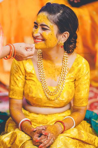 a woman in yellow is getting her face painted