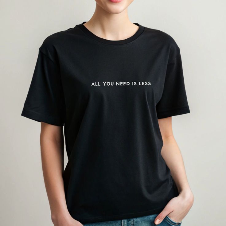 All You Need is Less - the perfect minimalist t-shirt to revolutionise your wardrobe. Created with eco-conscious besties and Mental health awareness in mind, this t-shirt is a light hearted reminder to take a step back and be mindful of the environment and remember sometimes less is more. Minimalist & Motivation Shirts https://etsy.me/4ap1Pic Yoga Clothes: https://etsy.me/4axsVUp Coffee Mugs: https://etsy.me/4cIpxHM Tote Bags: https://etsy.me/4cTKi3l " An extraordinarily imaginative print, the shirt was delivered very quickly and the recipient is totally happy with it. Thanks very much! " 💛 M. Size: For accurate fit we recommend measuring one of your own t-shirts and comparing sizes with our size guide in the listing photos above. S M L XL 1XL 2XL 3XL This is a made to order garment. Fulf Relaxed Fit T-shirt With Quote Print For Everyday, Minimalist Letter Print T-shirt For Everyday, Minimalist Letter Print T-shirt, Trendy Everyday T-shirt With Quote Print, Trendy Quote Print T-shirt For Everyday, Trendy Quote Print T-shirt, Minimalist Relaxed Fit Top With Letter Print, Minimalist Letter Print Tops With Relaxed Fit, Minimalist Tops With Letter Print And Relaxed Fit