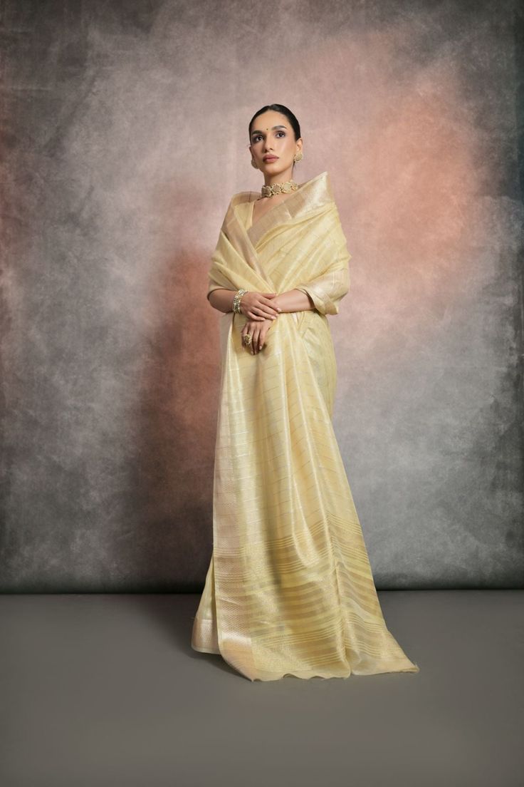 Saree Fabric : Tissue Cotton Saree Color : Very Pale Yellow Saree Length : 5.5 Meter Blouse Length : 0.8 Meter Saree Work : Zari Woven Stripes Saree Border : Zari Woven Border Wash : Dry Clean Elegant Designer Pre-draped Slub Silk Saree, Elegant Formal Cotton Silk Pre-draped Saree, Elegant Formal Pre-draped Cotton Silk Saree, Elegant Slub Silk Lehenga With Sheer Dupatta, Elegant Slub Silk Blouse Piece With Cutdana, Elegant Cutdana Blouse Piece In Slub Silk, Sheer Dupatta Slub Silk Blouse Piece For Wedding, Wedding Slub Silk Blouse Piece With Sheer Dupatta, Elegant Slub Silk Blouse Piece