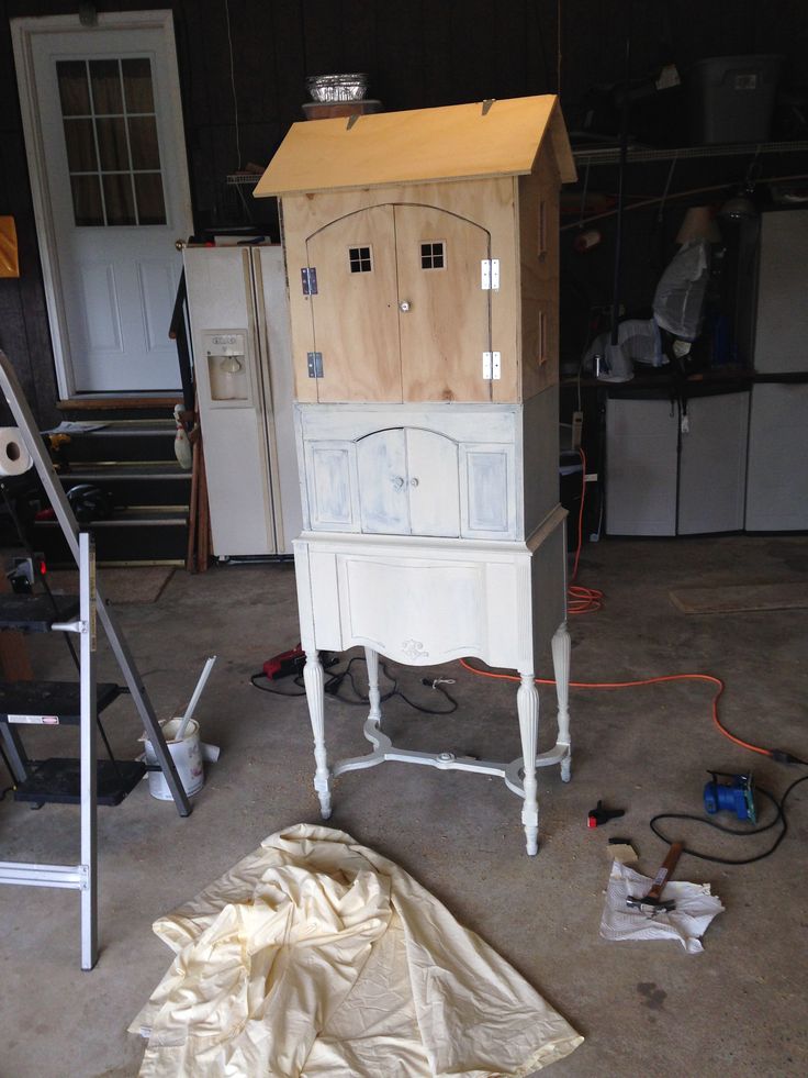 an old cabinet is being worked on in a garage