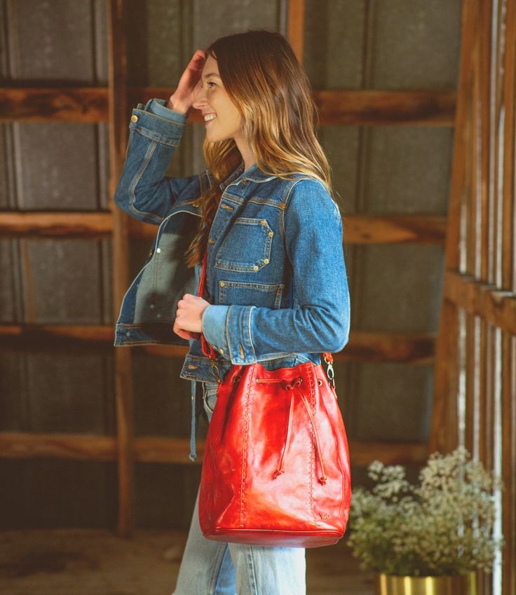 Everything and the kitchen sink (ok, not quite) can fit inside EVE.  EVE is a new bucket-style bag with a drawstring cinch top, wide flat bottom, and an adjustable and removable crossbody strap.  As tall as she is cute, EVE has a cool football topstitch effect up the front seams.  Inside find a zip pocket, two slip pockets and a key FOB.  Roomy and great for errands, EVE is the timeless silhouette youve been looking for. Spring Leather Bag With Zipper Pocket, Fall Crossbody Bucket Bag, Leather Bag With Zipper Pocket For Spring, Casual Leather Bucket Bag With Detachable Strap, Casual Bucket Satchel For On-the-go, Casual Satchel Bucket Bag For On-the-go, Fall Travel Crossbody Bucket Bag, Fall Travel Bucket Bag With Detachable Strap, Fall Adjustable Strap Crossbody Bucket Bag