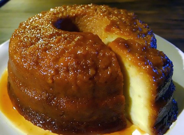 a bundt cake on a white plate with caramel sauce