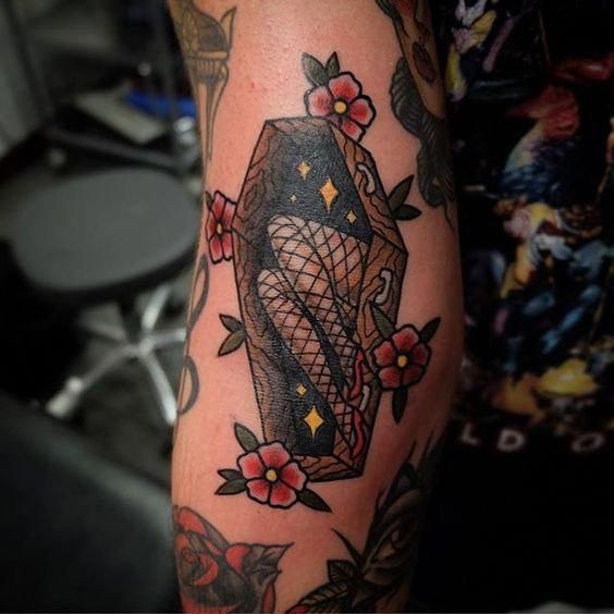 a woman's arm with tattoos on it