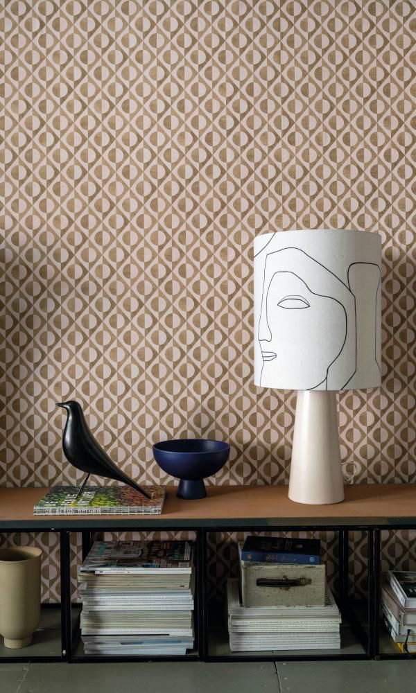 a lamp sitting on top of a wooden table next to a book shelf filled with books