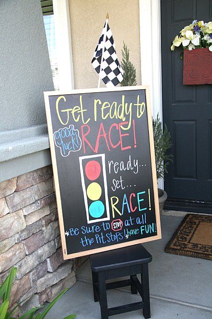 a sign that says get ready to race next to a door with a checkered flag on it