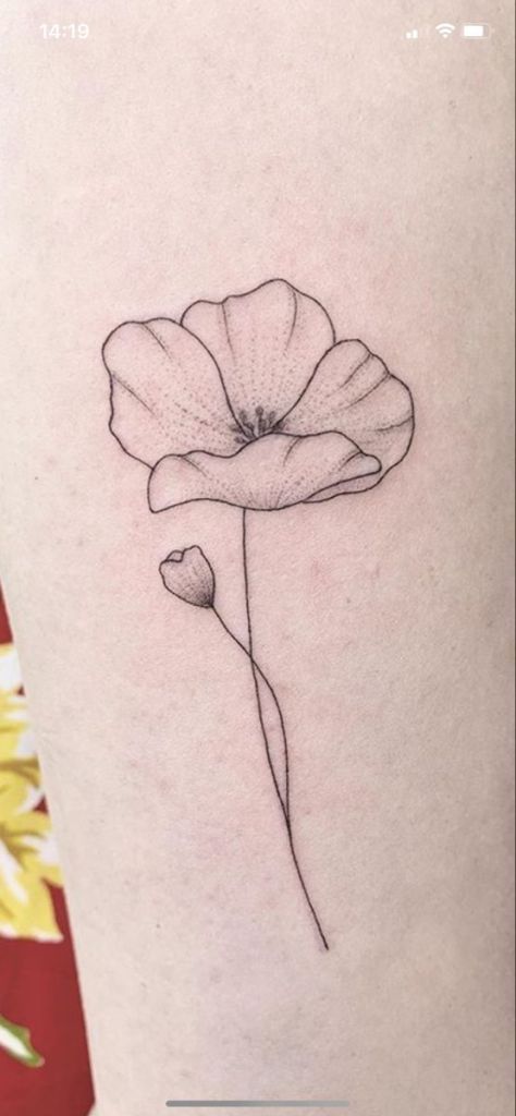 a single flower is shown on the back of a woman's leg, which has been