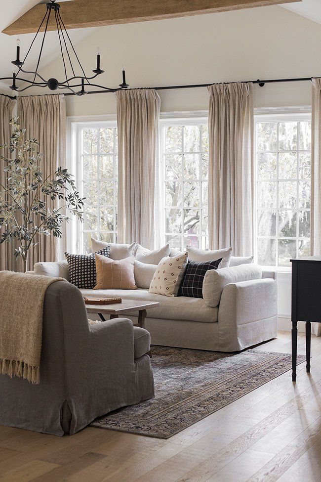 a living room filled with furniture and windows