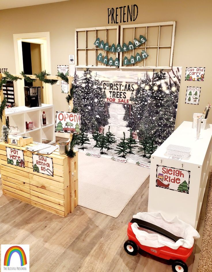 a christmas tree display in a store with wooden crates and signs on the front wall