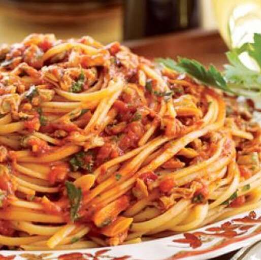 pasta with sauce and herbs on a plate