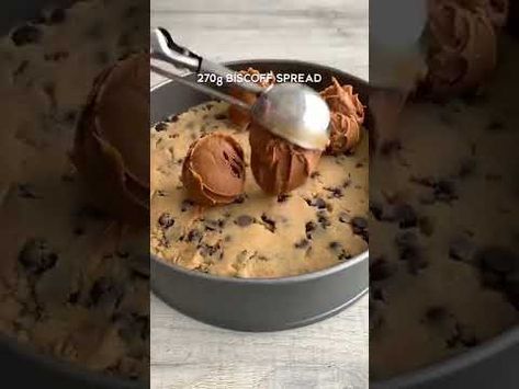 a pan filled with cake batter and chocolate chip toppings on top of each other