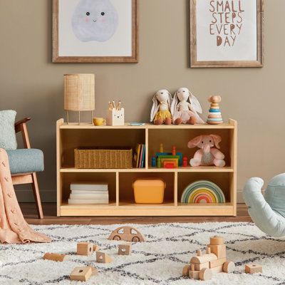 a child's playroom with toys, bookshelves and pictures on the wall