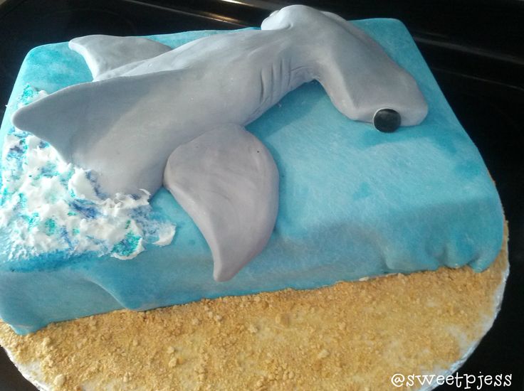 a cake that is shaped like a dolphin