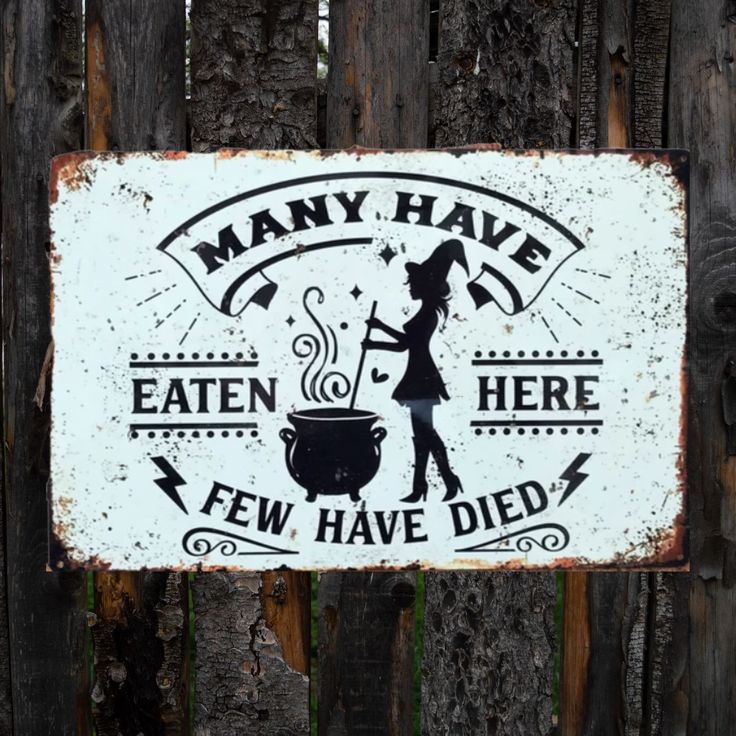 a sign that says many have eaten here few have died on the side of a wooden fence