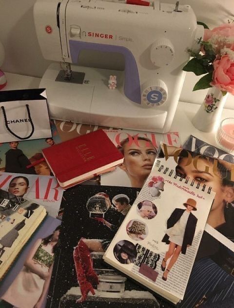 the sewing machine is next to many magazines