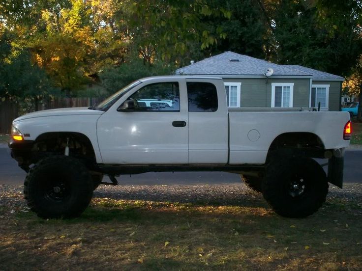 a white truck parked in front of a house