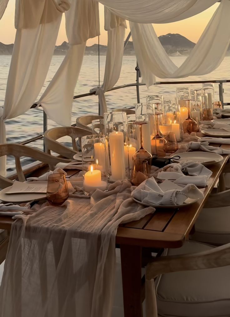 an outdoor dining area with candles on the table