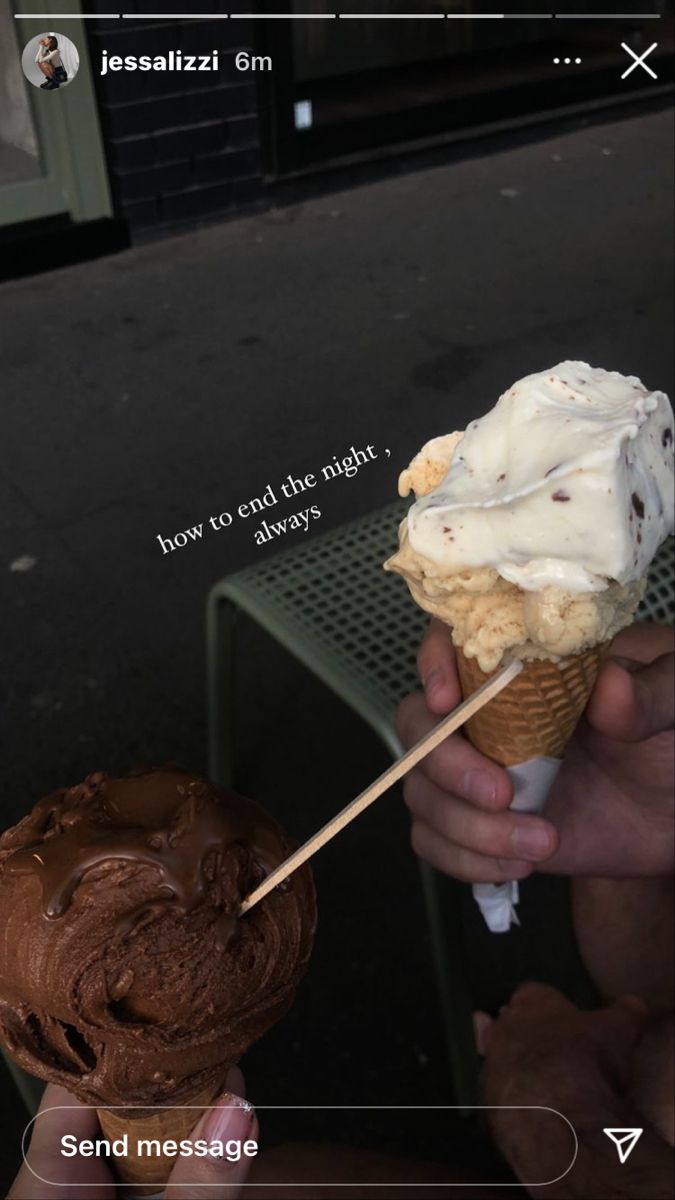 someone holding an ice cream cone with chocolate frosting on it, and another one has a stick sticking out of it