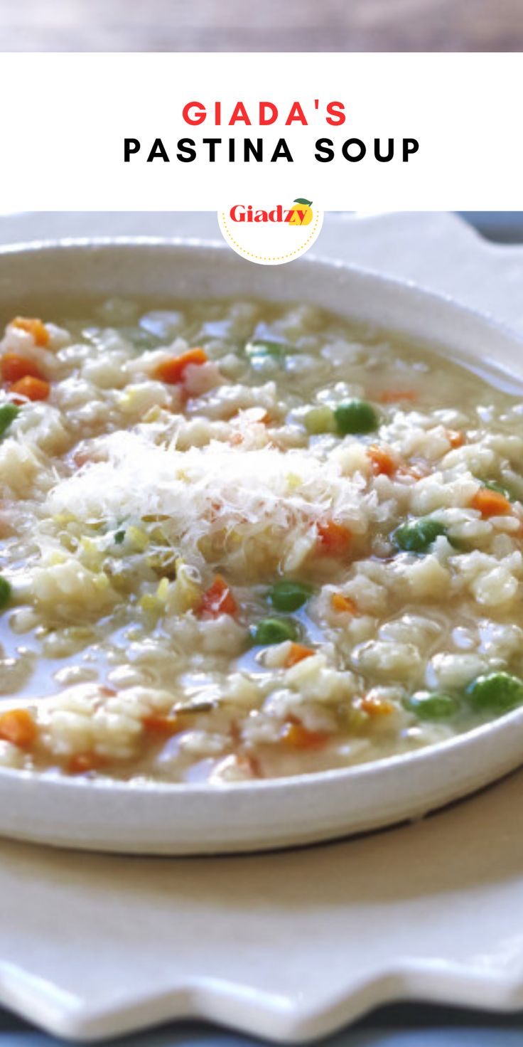 a white bowl filled with pasta and vegetables on top of a blue table cloth next to a