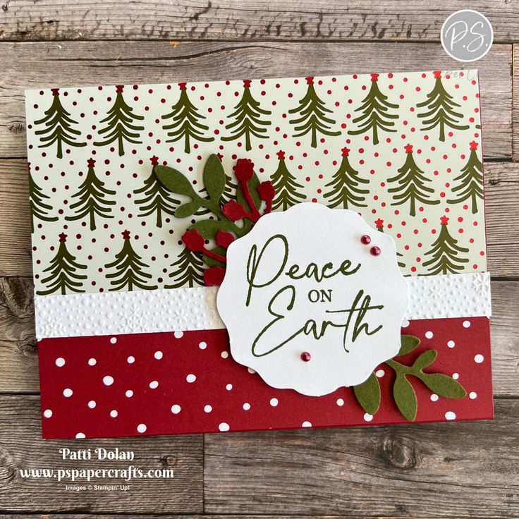 a handmade christmas card with the words peace on earth written in green and red