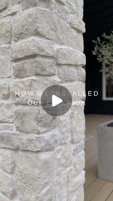 a white brick wall next to a potted plant