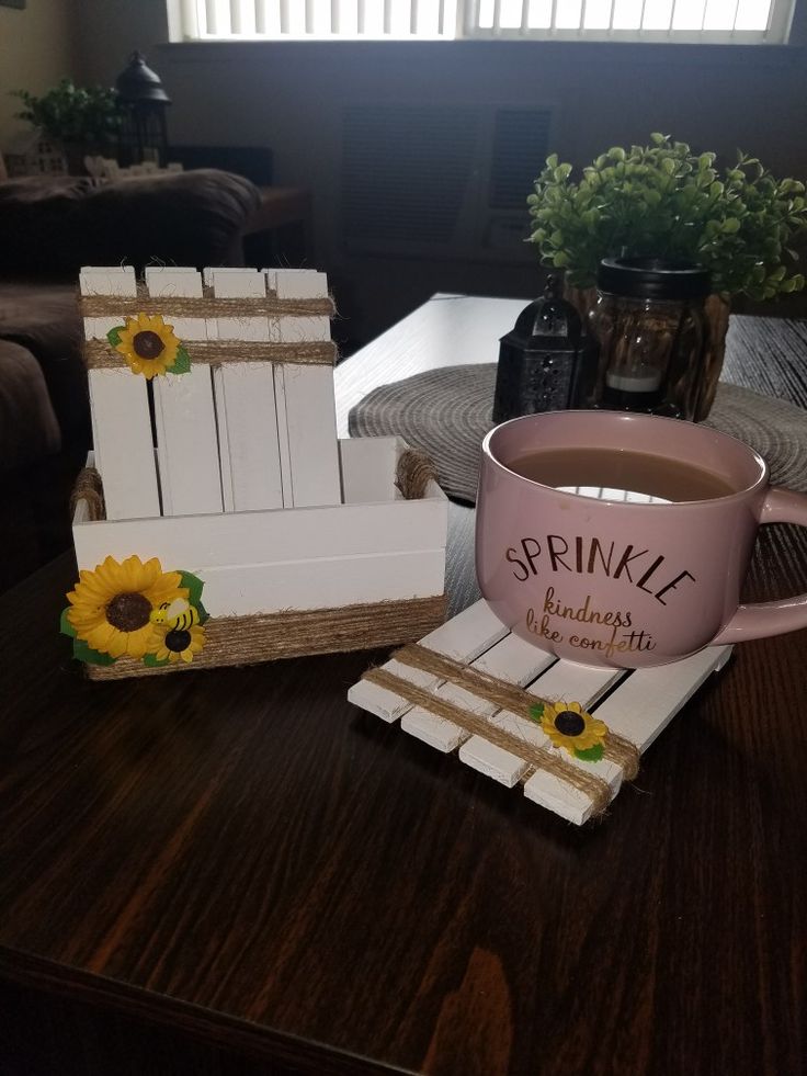 a cup of coffee sitting on top of a table next to some small pieces of wood