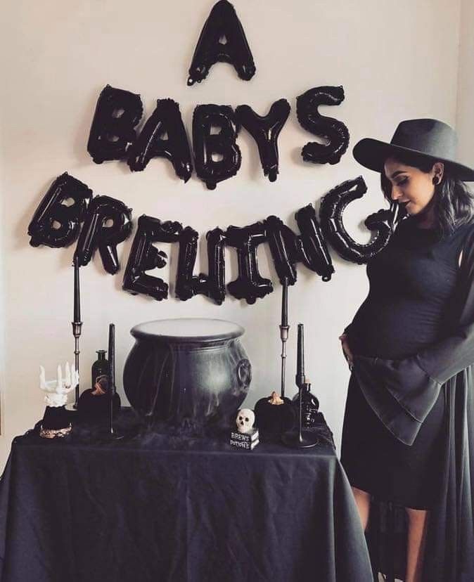 a woman standing in front of a table with balloons that say baby's brunch