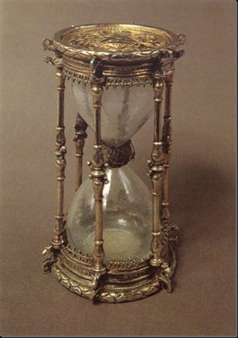 an old fashioned hourglass with gold trimmings