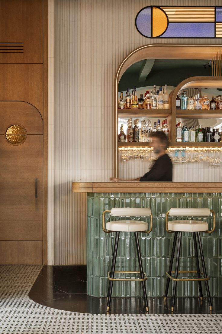 a bar with two stools in front of it