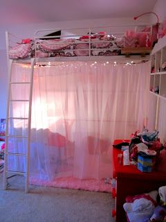 a bedroom with a bunk bed and pink curtains