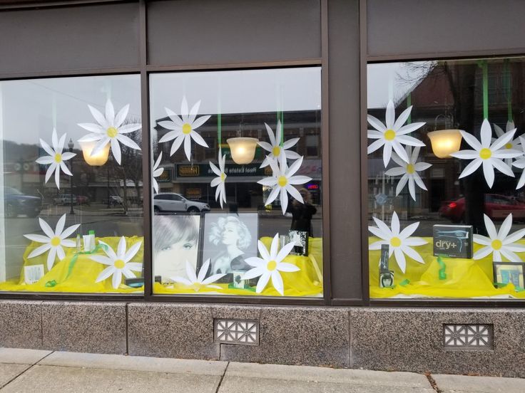 the window is decorated with white flowers and pictures on it's sidewalls