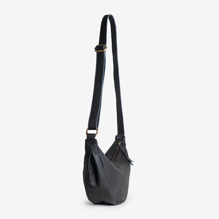 a black leather bag with straps hanging from it's side, on a white background