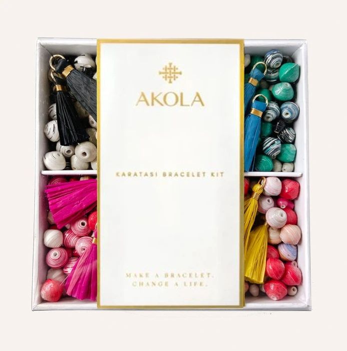 an assortment of assorted beads in a box with the word akola written on it