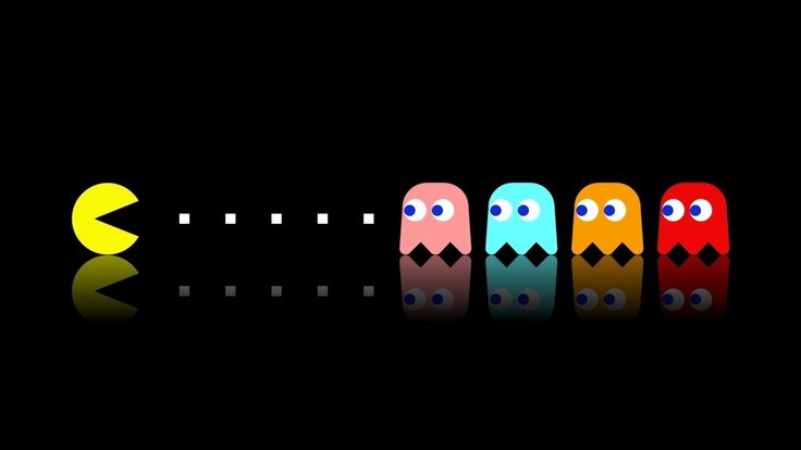 four pacman are lined up in the dark