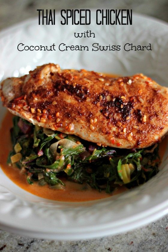 thai spiced chicken with coconut cream stuiss chard on a white plate