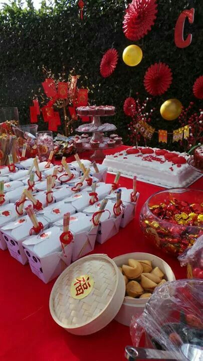 a table filled with lots of food on top of a red carpet