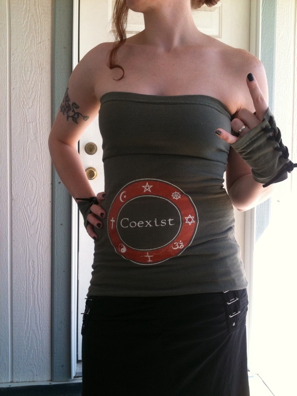 a woman in a tank top with her hands on her hips and the word coextst printed on it