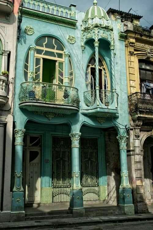 an old building with balconies painted blue