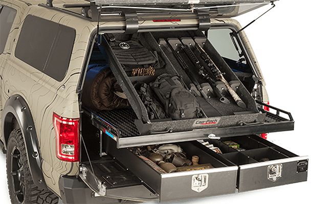 the back end of a truck with its cargo compartment open and tools in it's trunk