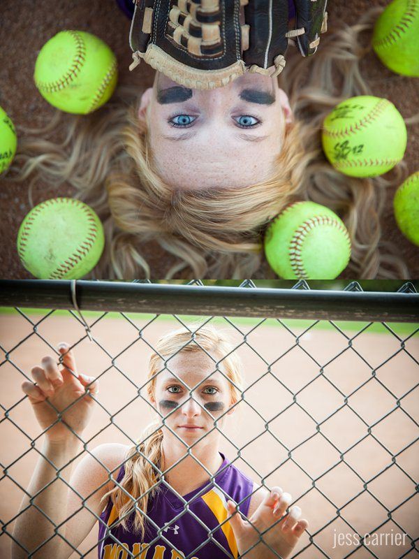 a girl with her face painted like a baseball player behind a chain link fence and balls in the background