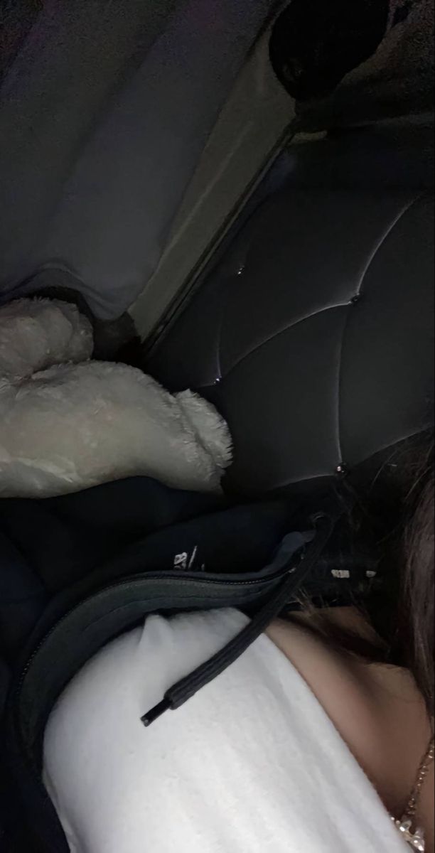 a woman sleeping in the back seat of a car