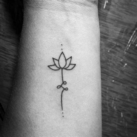 a small lotus tattoo on the wrist