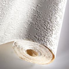 a roll of white paper sitting on top of a table