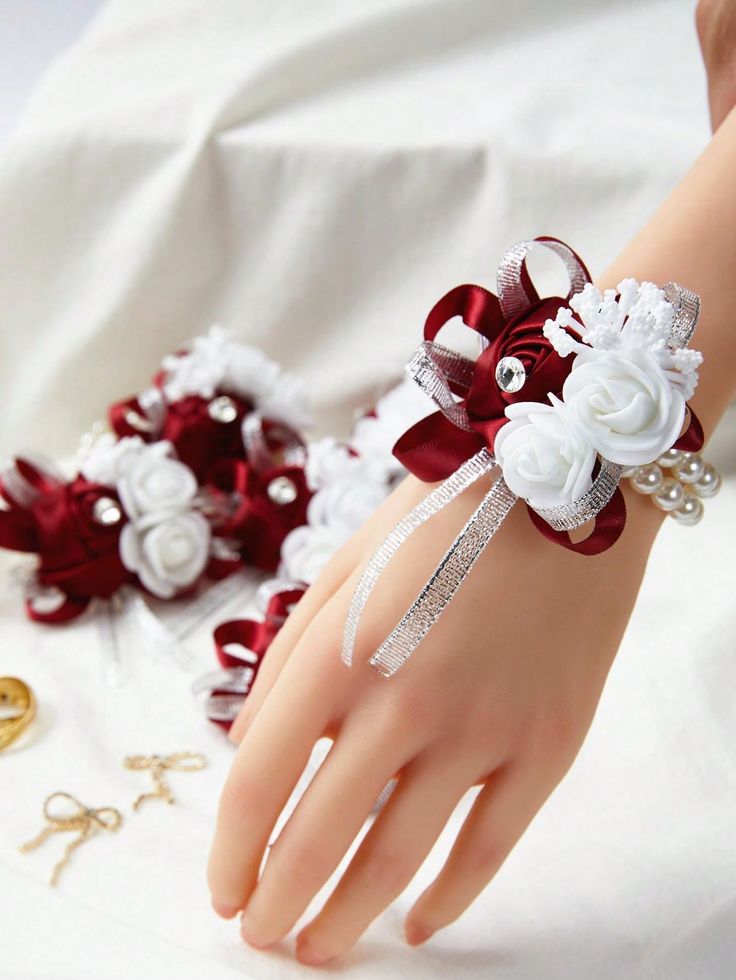 a close up of a person's hand wearing a bracelet with flowers on it